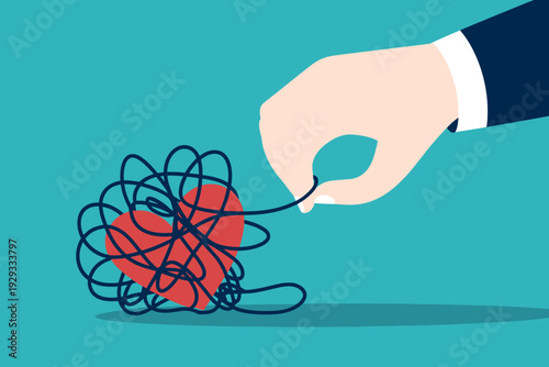 Hand untangling knot of threads around red ball