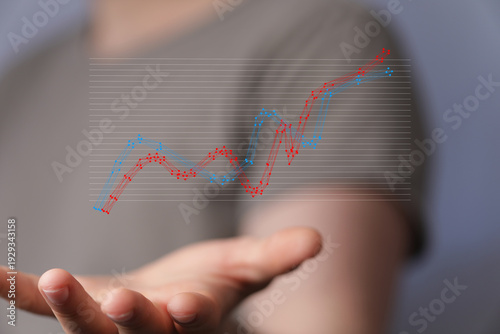 Hand holding a graph repres...