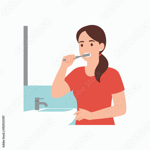 Woman brushing teeth in bathroom oral hygiene routine.