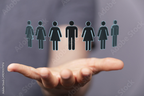 Hand holding a group of peo...