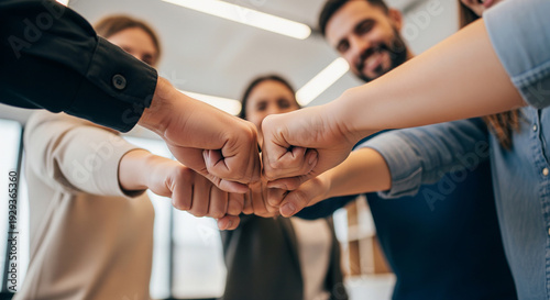 Low angle shot of team connecting fists together perfect for strong partnership and shared objectives