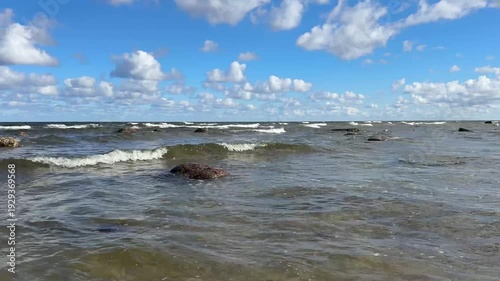 Open sea with moderate waves and dynamic cloud formations. Natural ocean sound included. High resolution 4K coastal footage.
