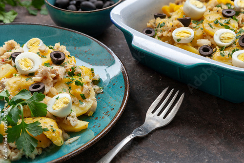 Traditional Homemade Portuguese Bacalhau a Gomes de Sa salted cod baked with potatoes, onions served with eggs and olives
