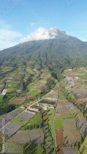 Aerial View of Mountain Terraced Farmland and Reservoir Near Village on a Clear Sunny Day