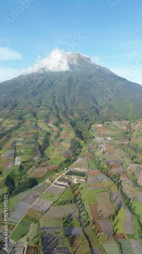 Aerial View of Mountain Terraced Farmland and Reservoir Near Village on a Clear Sunny Day