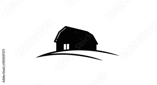 Black silhouette of a barn on rolling hills