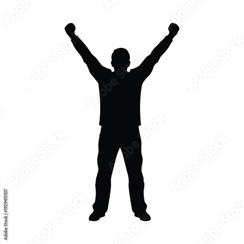 Confident man celebrating success with arms raised in triumph