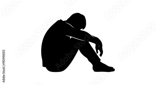Fotografie Silhouette of a person sitting alone with their head down, conveying a sense of sadness or despair