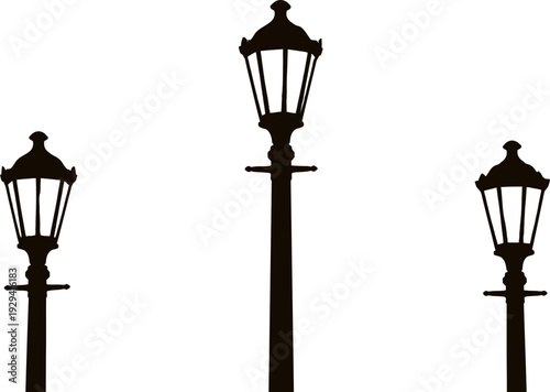 Silhouette of three classic street lamps on poles