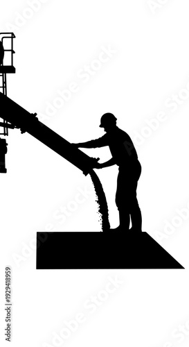 Silhouette of a construction worker pouring wet concrete from a large chute onto a surface.