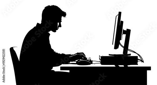 A silhouette of a person sitting at a desk, focused on working or typing on a computer.