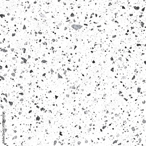 A white surface with black and gray speckles, resembling granite or a similar textured material.