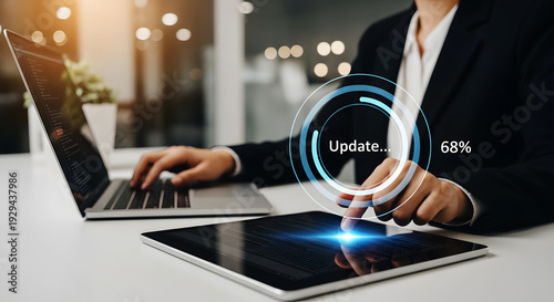 Person updating software on tablet and laptop with progress bar technology update