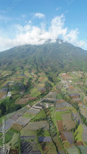 Aerial View of Mountain Terraced Farmland and Reservoir Near Village on a Clear Sunny Day