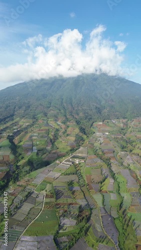 Aerial View of Mountain Terraced Farmland and Reservoir Near Village on a Clear Sunny Day