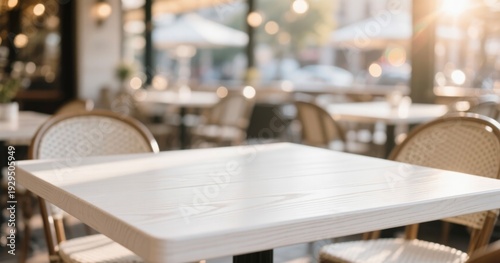 Empty White Wooden Table in Outdoor Café with Sunlight and Blurred Background