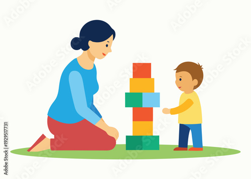 Patient mother and her toddler son building a tall colorful tower of blocks together on the grass.