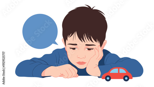 Sad little boy leaning on a table and looking at a toy car with a blank speech bubble for his thoughts or words.