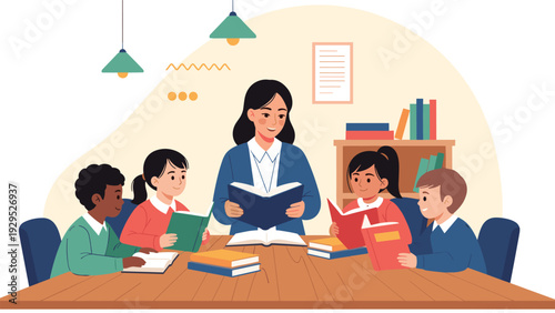 Female teacher sits at a table and reads a book to a group of diverse elementary school children in a library.