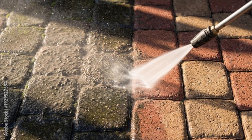 Close up texture of half cleaned paver stones showing transformation up