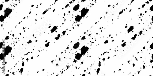 Abstract splatter pattern with irregular black shapes on a white background