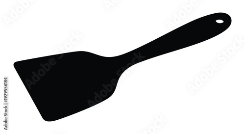 A stark black silhouette of a kitchen spatula rests against a bright clean white background silhouette high quality professional