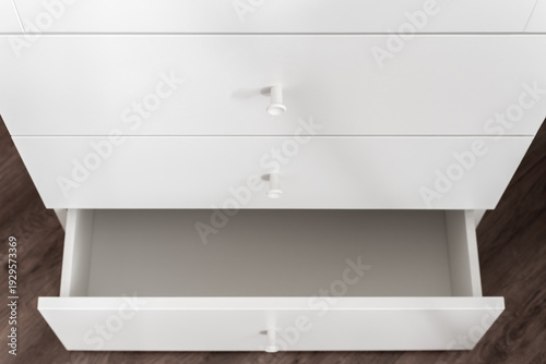 White cabinet with single open drawer in minimal interior