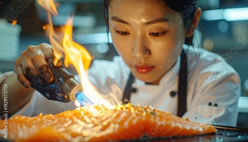 Chef Preparing Salmon with Torch in Kitchen.