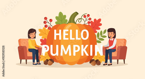 Two smiling women sit in armchairs next to a giant pumpkin with fall decorations