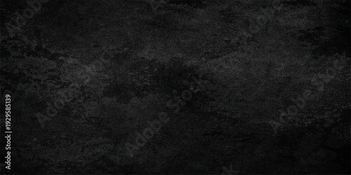 A dark and vintage black and white grunge background features a rough textured stone wall pattern with a dirty gray concrete surface and an old blank chalkboard frame for a moody backdrop design