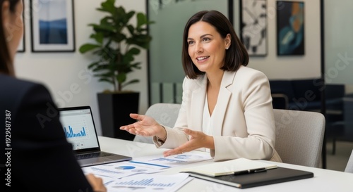 Professional woman discussing business plans with a colleague in an office setting