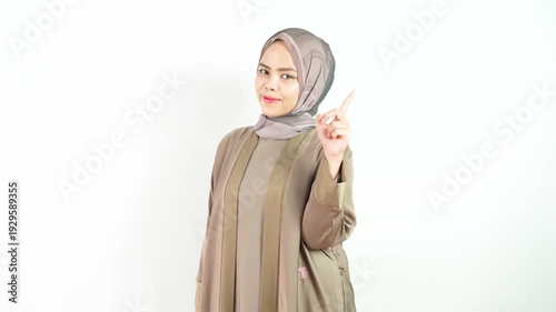 Muslim Woman with Smiling Expression and Pointing Back Gesture Isolated on White Background in Studio 4k