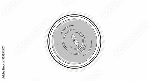 Top-down view of a bowl of creamy soup with swirling patterns and a basil leaf