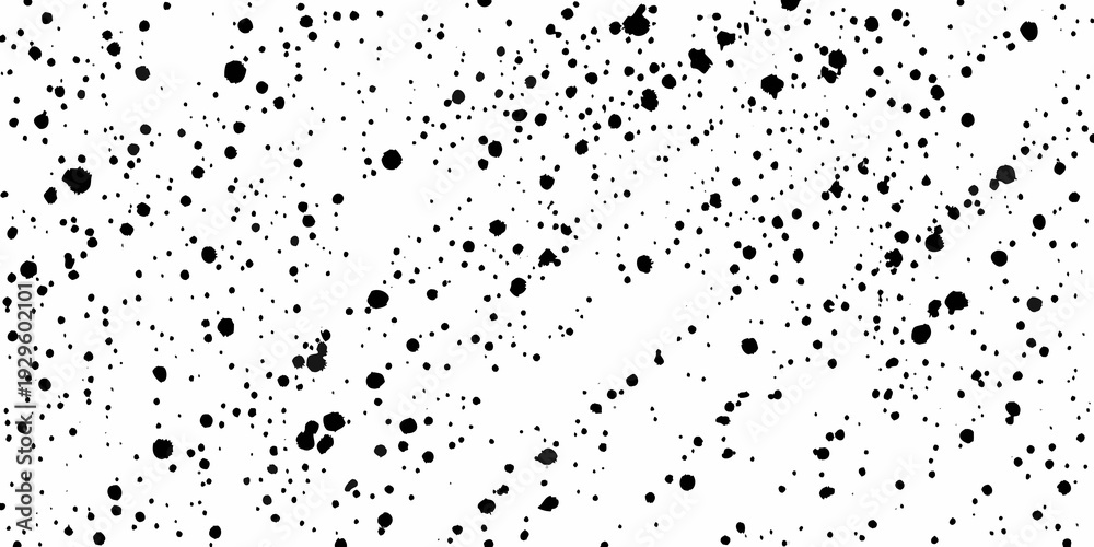 Obraz premium Abstract splatter pattern with varying sizes of black ink dots on white