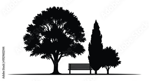 A striking black and white image depicting trees a park bench and a serene landscape presented as a silhouette