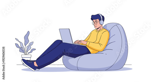 Relaxed man wearing headphones and using a laptop while sitting in a large bean bag chair in a minimalist room environment.