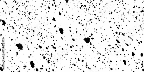 Abstract splatter pattern of black ink on a stark white background