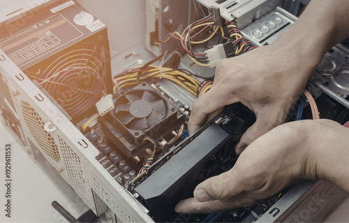 Technician installing computer hardware in modern workstation