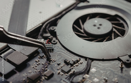 Technician repairing computer motherboard with screwdriver