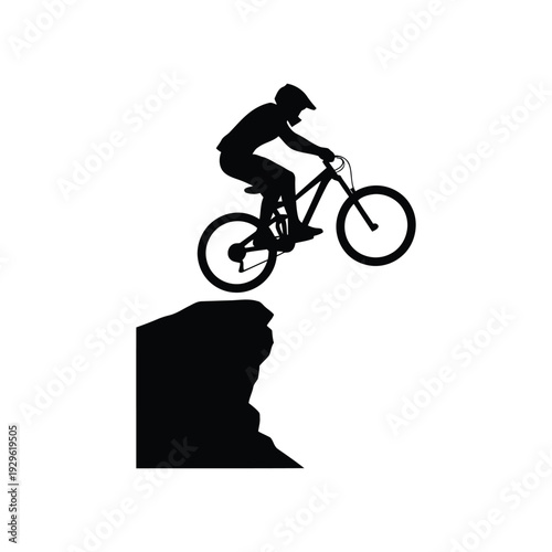 Mountain biker jumping cliff edge performing extreme sport trick on bicycle with helmet