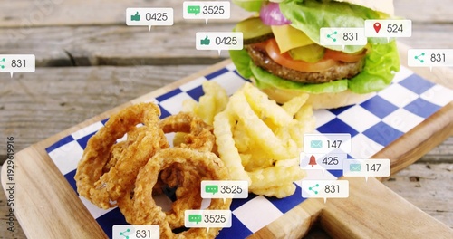 Showing burger, crinkle fries, onion rings on wooden board with blue-check liner, overlays