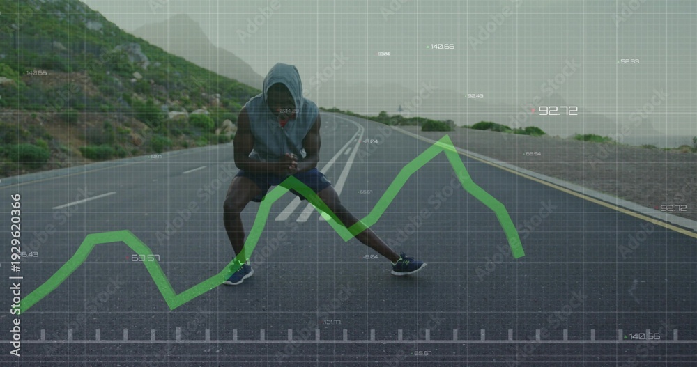 Naklejka premium Stretching runner wearing hooded top lunging, checking phone on coastal road, green graph overlay