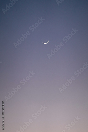 Принти на полотні Minimalist view of a silver crescent moon in the clear twilight sky