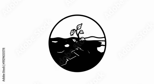 A small plant sprouts from cracked earth within a circular frame