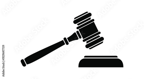 A striking black silhouette depicts a gavel resting on a sound block symbolizing justice and legal proceedings silhouette