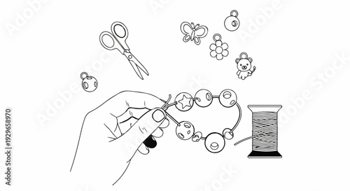 Hand stringing beads onto wire with scissors, thread, and charms scattered
