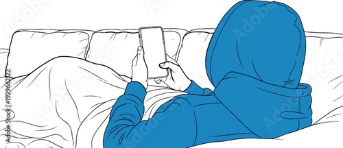 Person in blue hoodie reclines on couch, engrossed in a smartphone