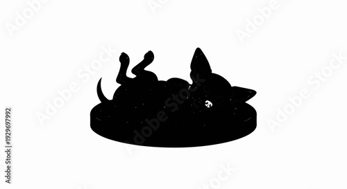 Black silhouette of a playful dog lying on its back with paws in the air