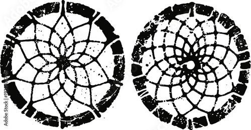 Two black circular cracked patterns with radial symmetry and irregular broken edges