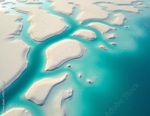 Aerial drone photography of turquoise glacial river delta branching through white sandbanks. Orthographic top-down perspective reveals abstract organic channel patterns with underwater caustic light c